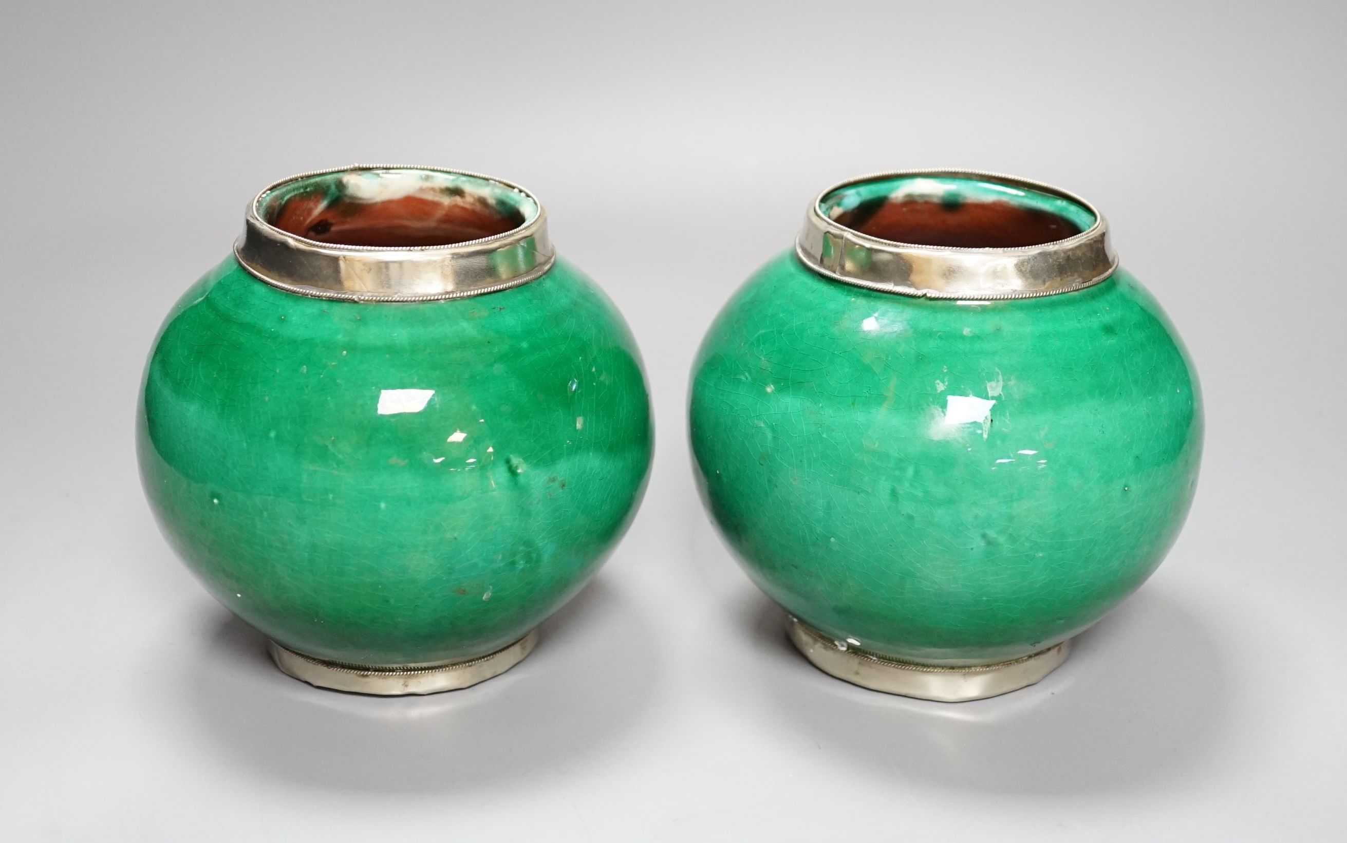 A pair of Tibetan green glazed vases - 14cm high
